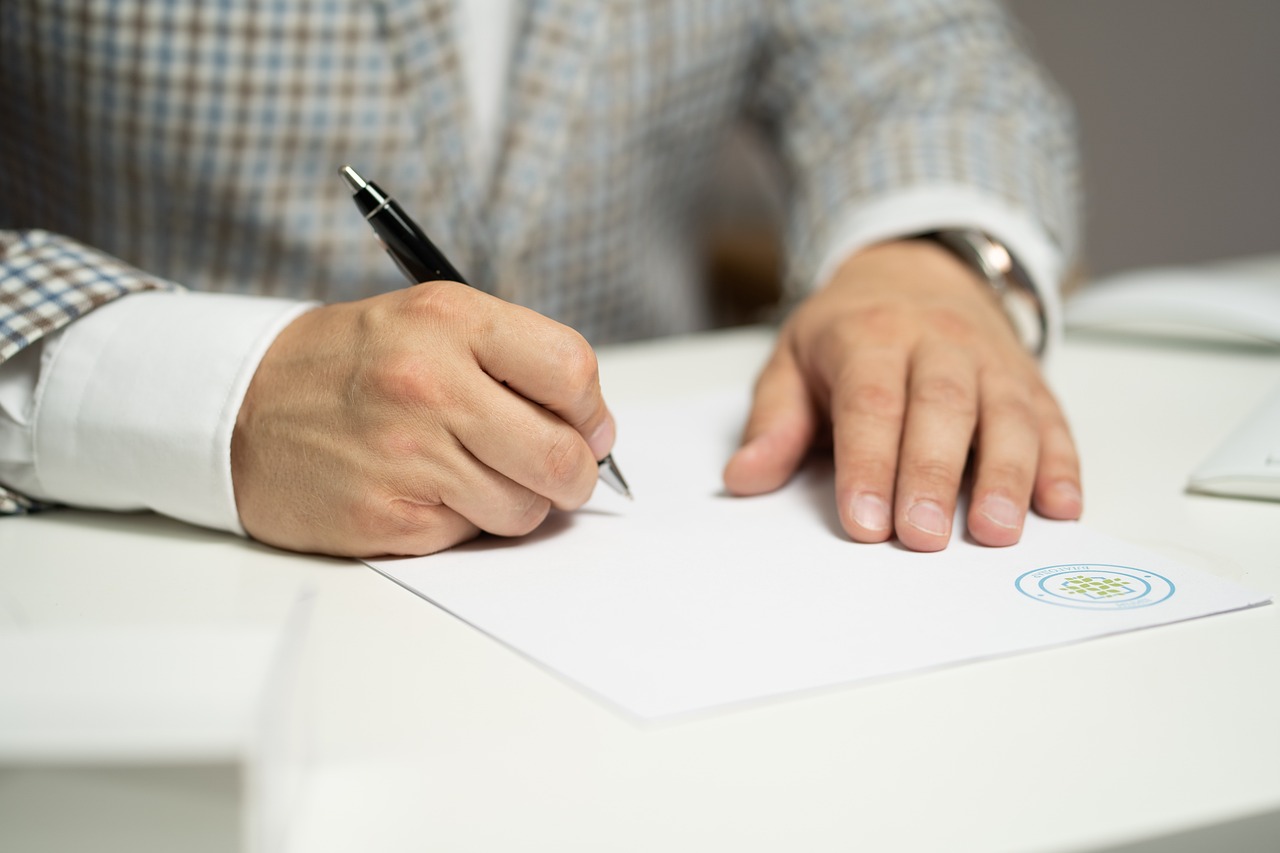 Man signing a car document