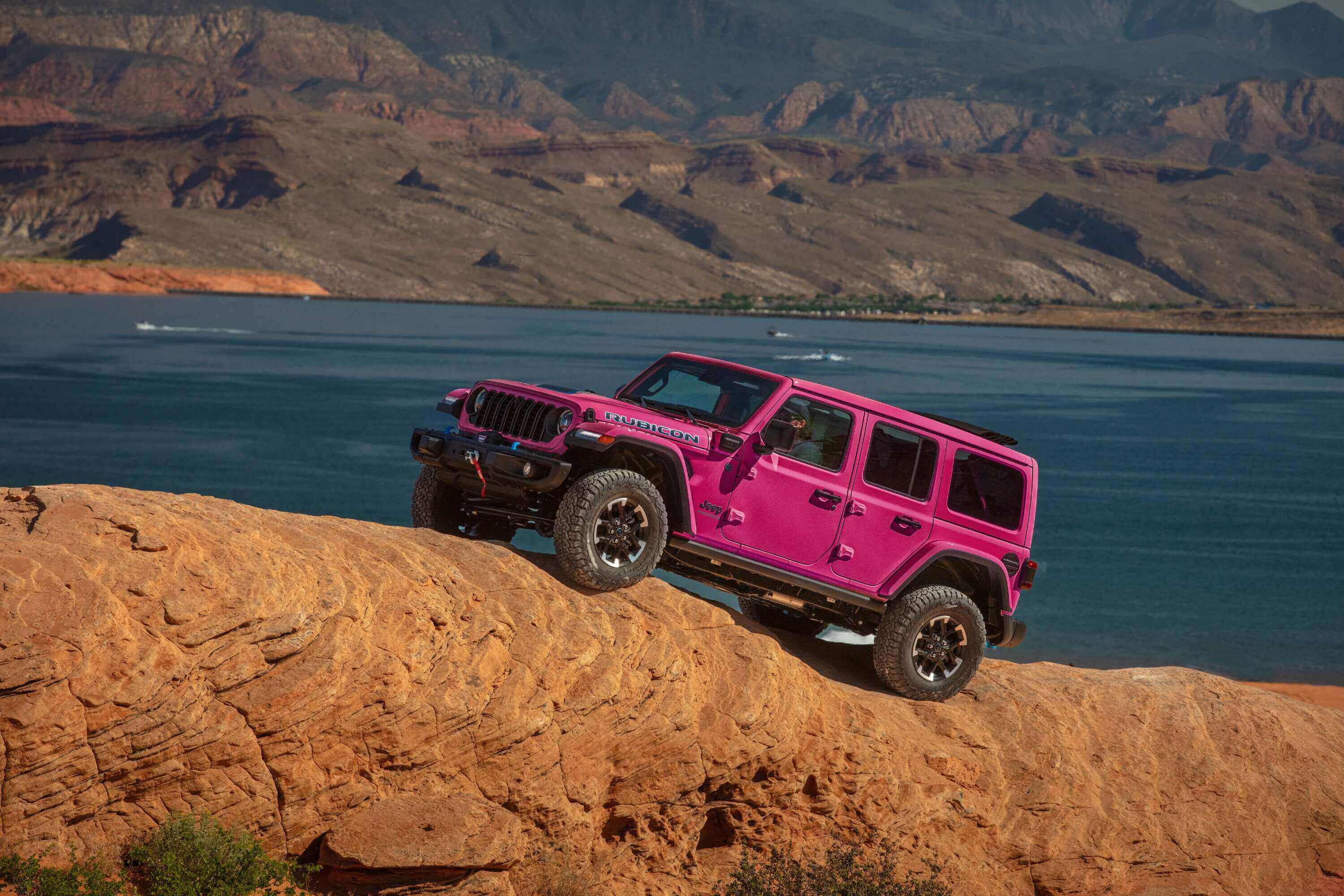 pink Jeep Wrangler on a hill