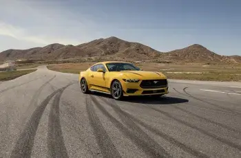 yellow car ford mustang on the road