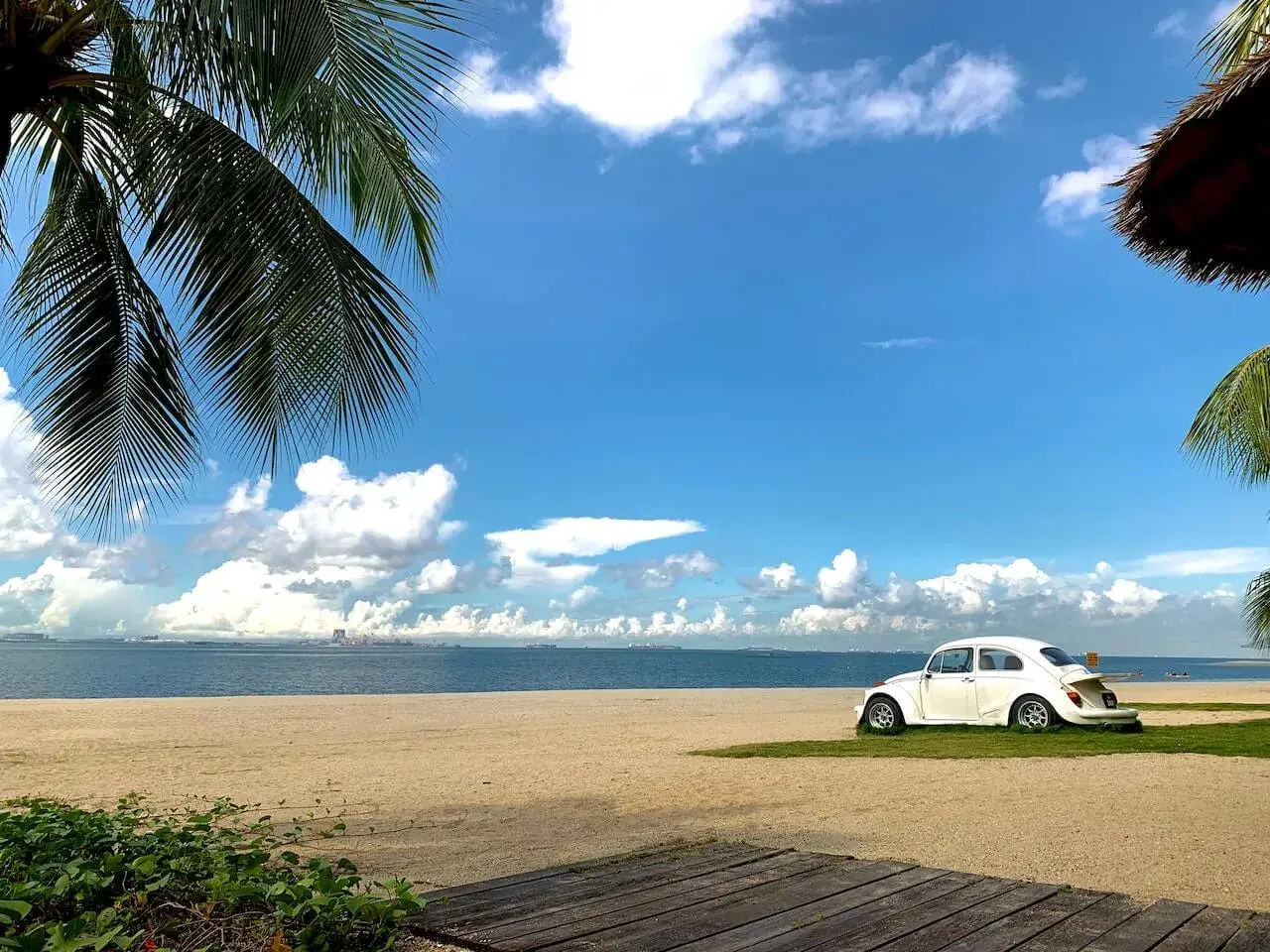A White Beetle Car Parked on Seashore