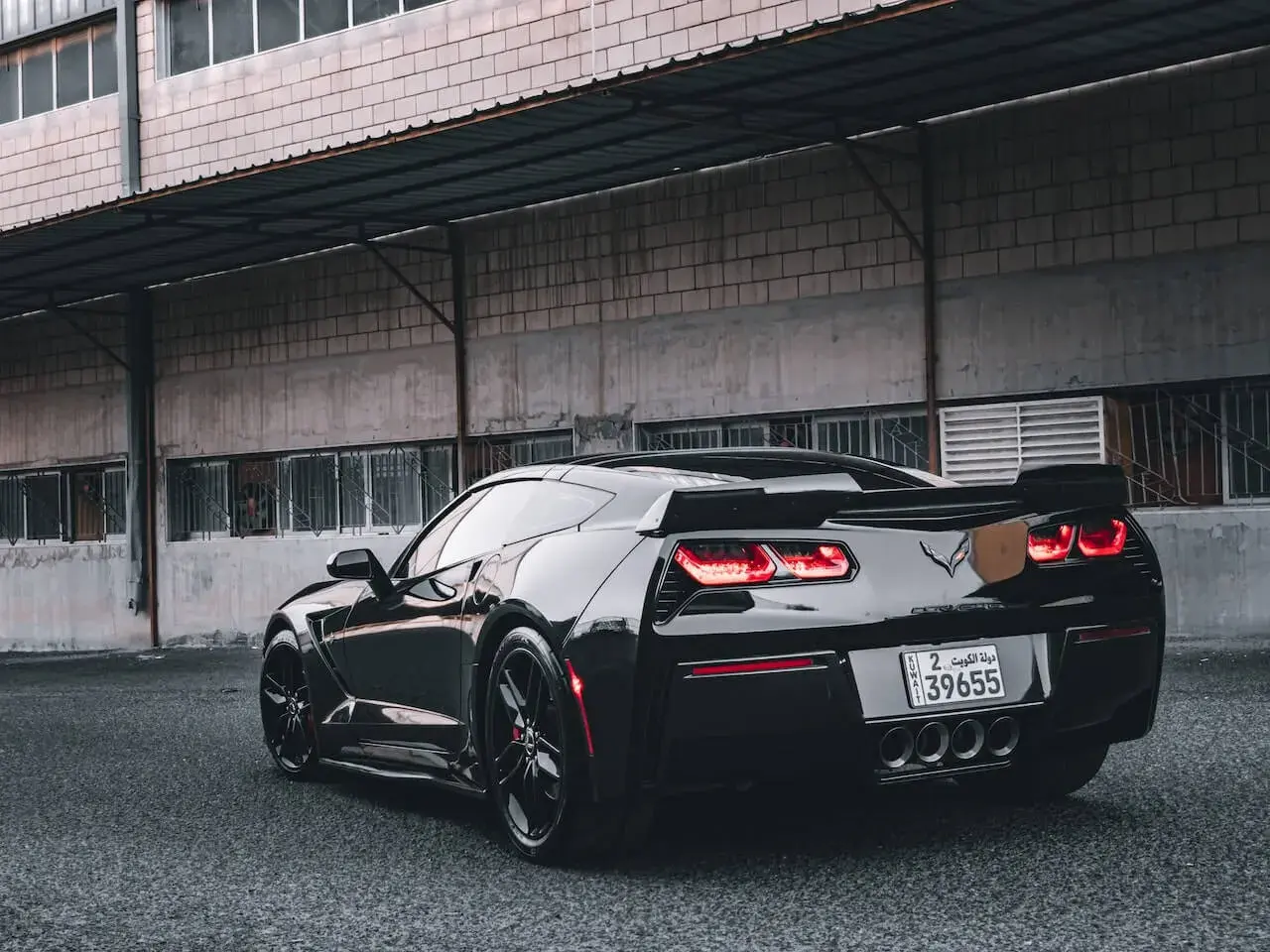 A Black Corvette Parked Under a Roof