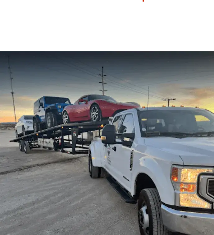 A white car loaded on a trailer