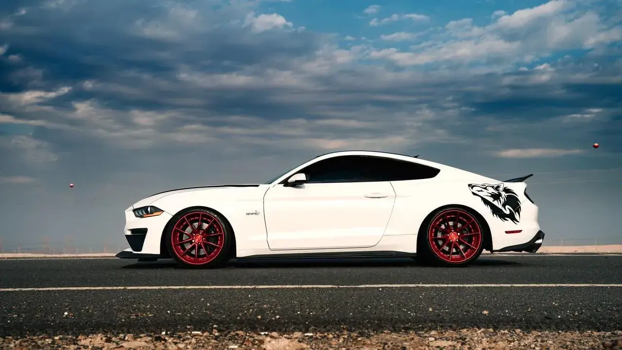 white mustang on the road