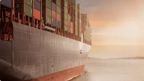 A ship sailing in the ocean carrying containers  