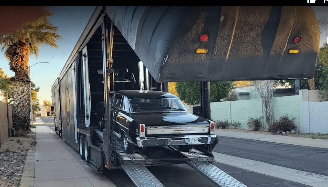 A car loading on an enclosed trailer