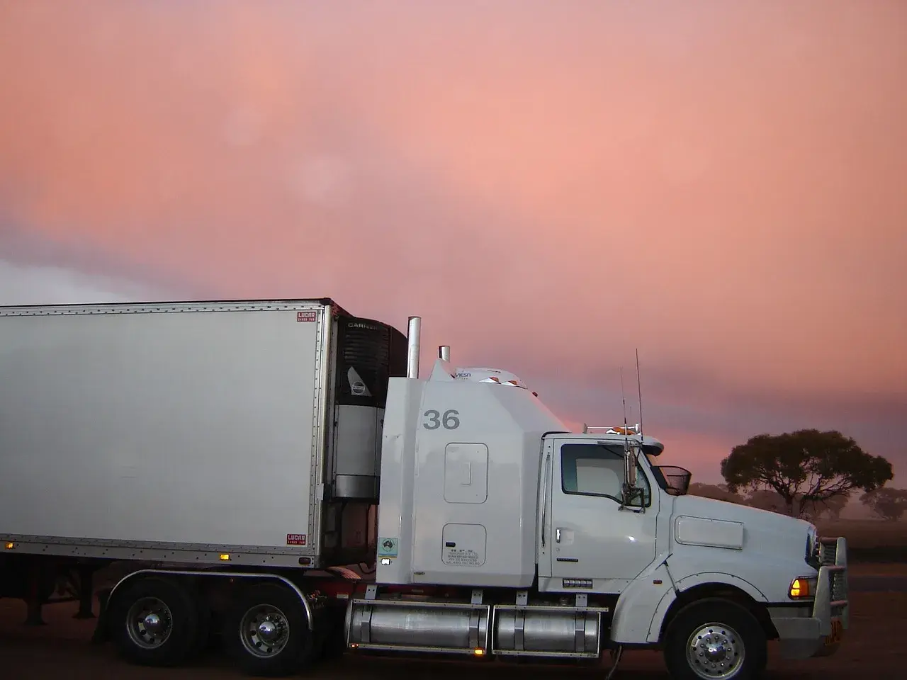 White truck behind him sunset