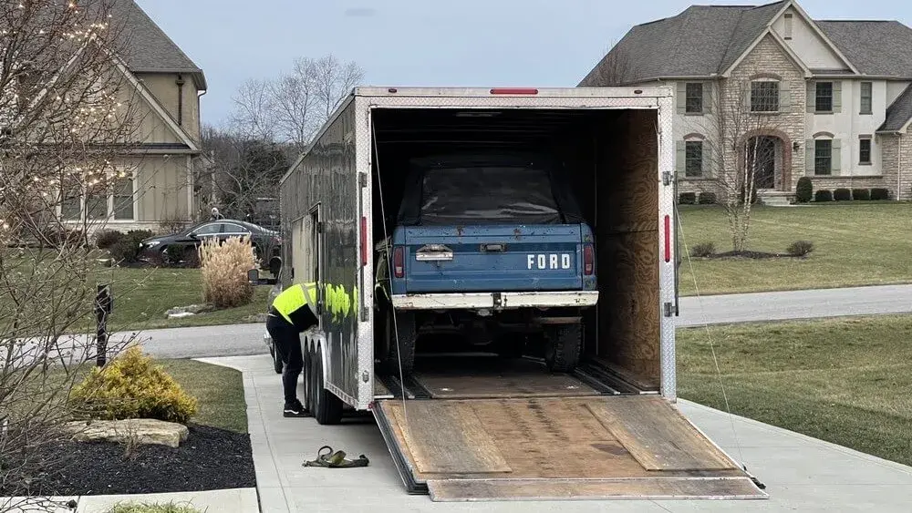 A ford going into enclosed carrier